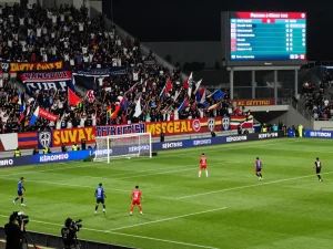 Fans cheering passionately during a live soccer match at https://keotructuyen.com.mx/ highlighting real-time updates for sports betting.